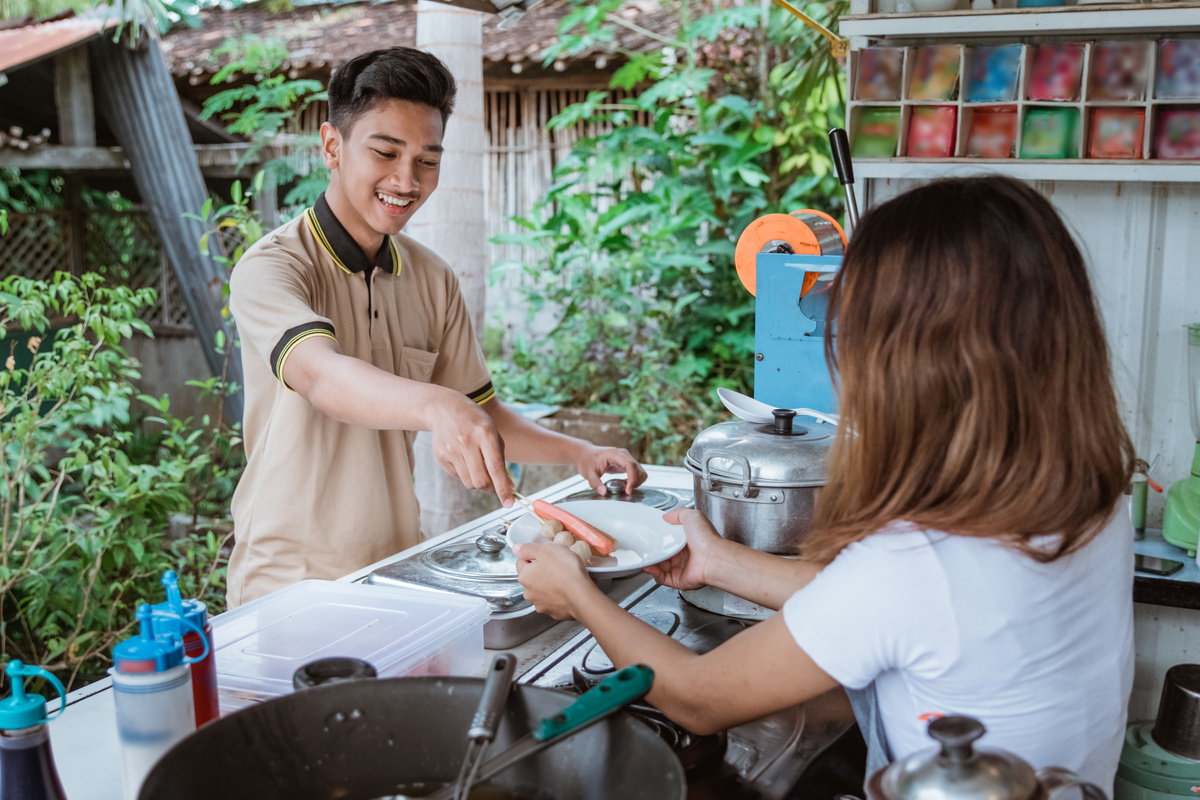 Customer Picking His Food from Small Street Food Seller